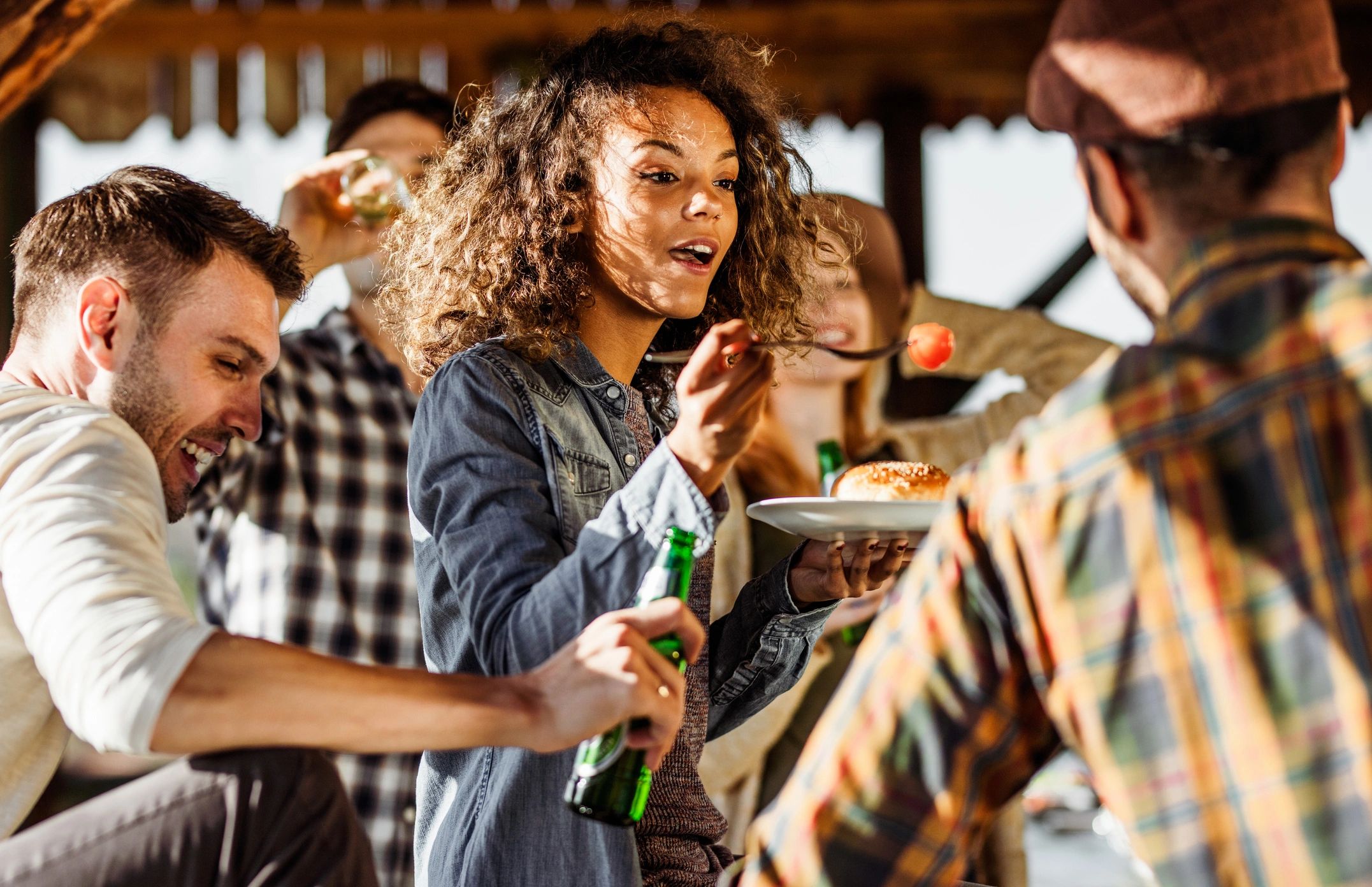 Friends enjoying food together at an outdoor party