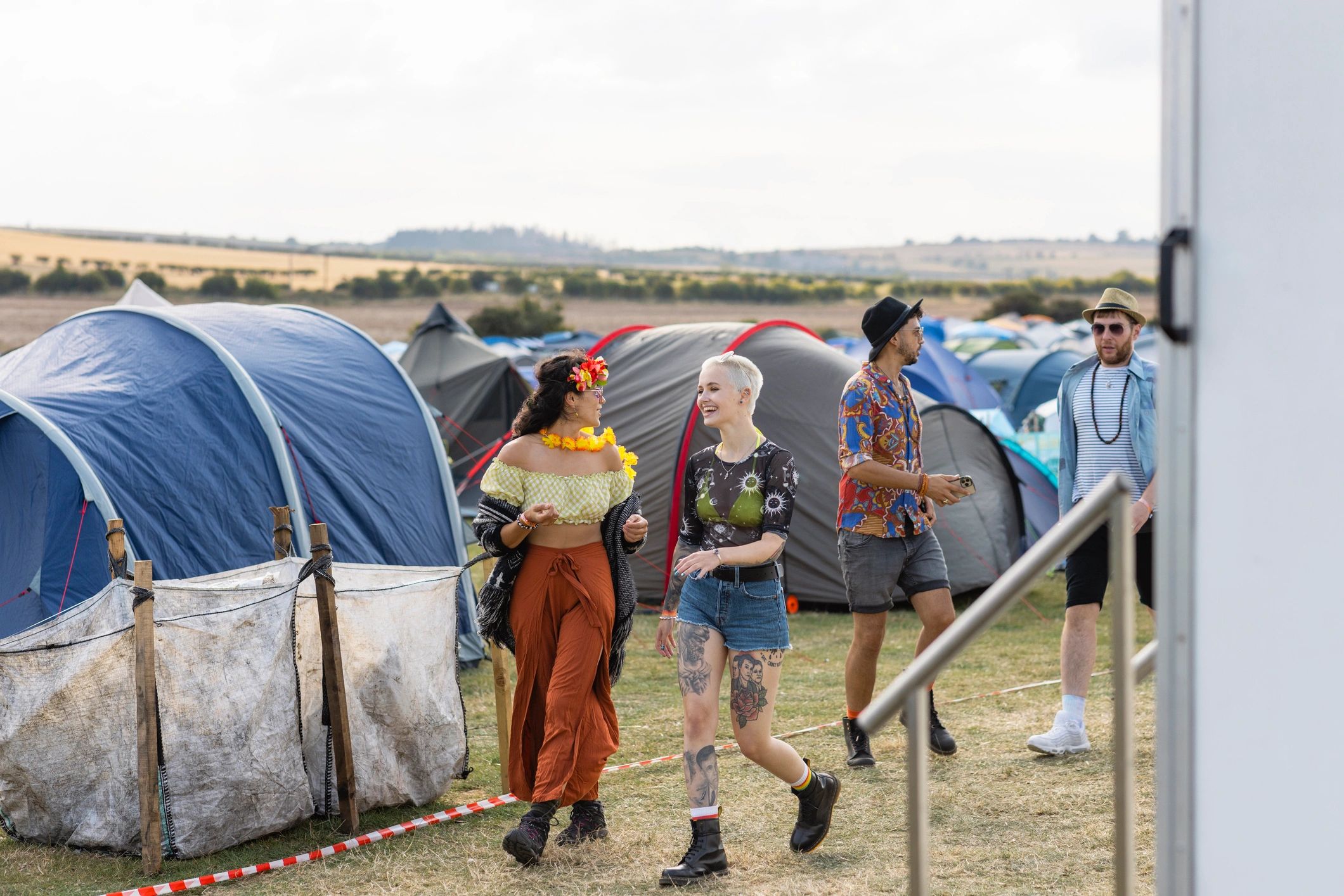 Outdoor event campsite with tents and people