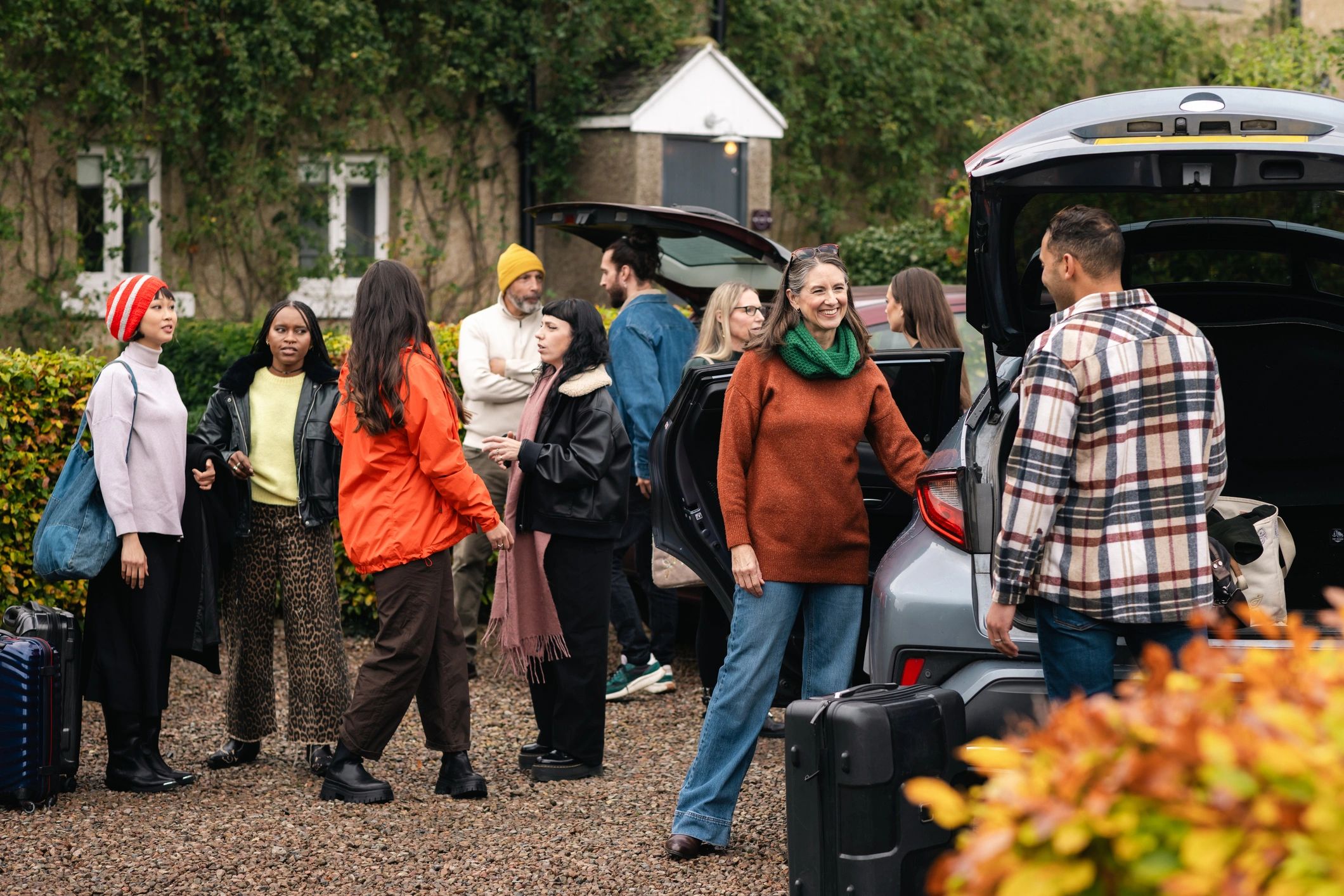 Friends gathering beside vehicles outdoors before a game day
